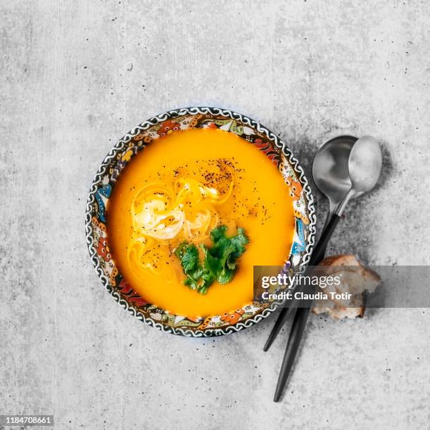 bowl of squash soup on gray background - soup vegtables stock-fotos und bilder