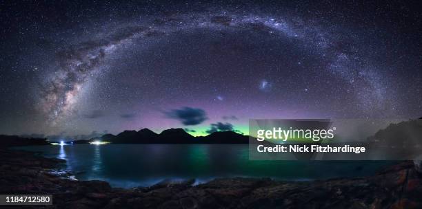 the milky way arches over the hazards while the aurora australis glows beyond, freycinet national park, tasmania, australia - aurora australis stock pictures, royalty-free photos & images