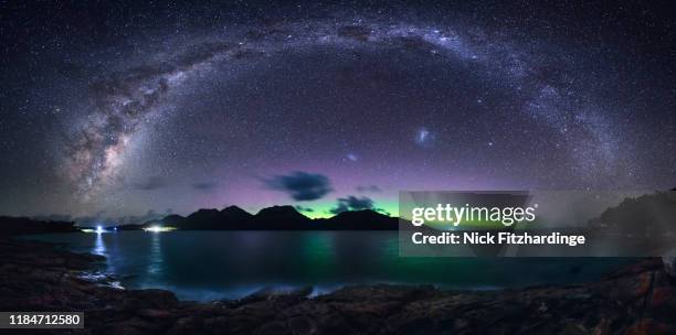 the milky way arches over the hazards while the aurora australis glows beyond, freycinet national park, tasmania, australia - aurora australis bildbanksfoton och bilder