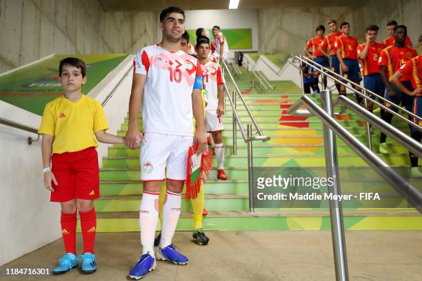 Islom Zairov of Tajikistan in the tunnel with a player escort before the FIFA U-17 World Cup Brazil 2019 group E match between Spain and Tajikistan...