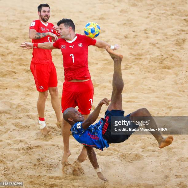 Ozu Moreira of Japan is challenged by Sandro Spaccarotella of Switzerland during the FIFA Beach Soccer World Cup Paraguay 2019 group A match between...