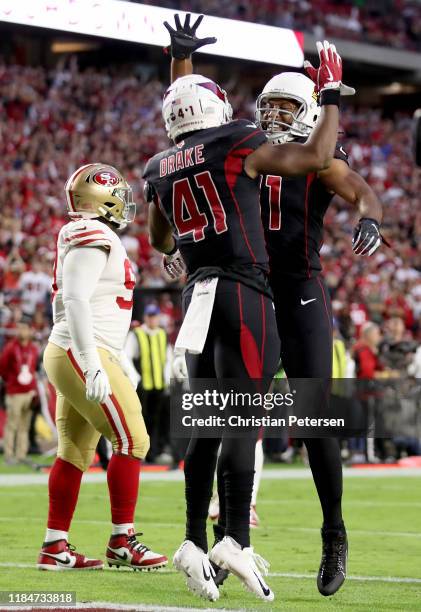 Running Back Kenyan Drake of the Arizona Cardinals and teammate Larry Fitzgerald of the Arizona Cardinals celebrate his touchdown in the first...