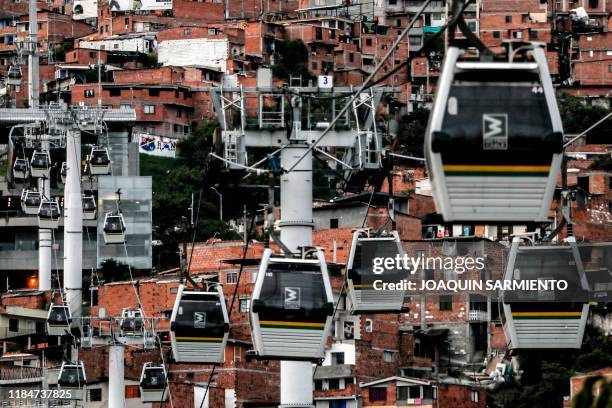 View of the metro cable system at the Comuna 13 neighborhood in Medellin, Colombia, on November 11, 2019. - With 25,000 monthly visits, tourism has...