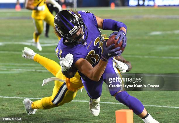 Willie Snead of the Baltimore Ravens gets past Marqui Christian of the Los Angeles Rams and runs into the end zone for a touchdown in the fourth...