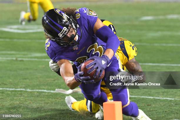 Willie Snead of the Baltimore Ravens gets past Marqui Christian of the Los Angeles Rams and runs into the end zone for a touchdown in the fourth...