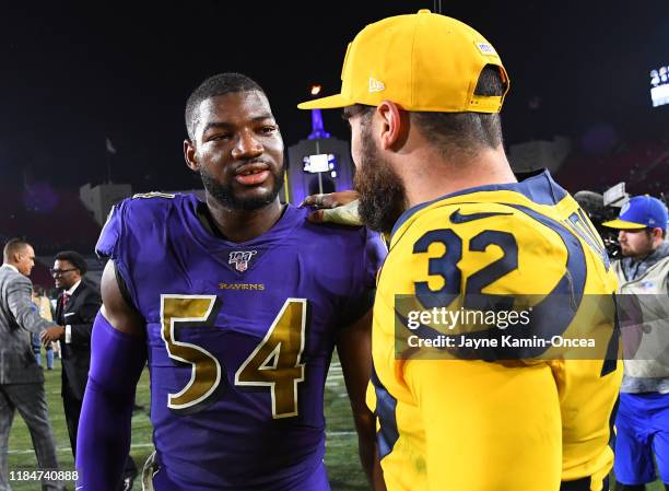 Tyus Bowser of the Baltimore Ravens talks with Eric Weddle of the Los Angeles Rams after the game at the Los Angeles Memorial Coliseum on November...