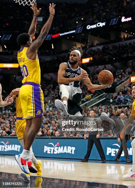 Patty Mills of the San Antonio Spurs drives against Troy Daniels of the Los Angeles Lakers in the second half at AT&T Center on November 25 2019 in...