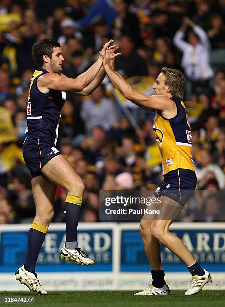 Jack Darling and Mark Nicoski of the Eagles celebrate a goal during the round 16 AFL match between the West Coast Eagles and the Geelong Cats at...