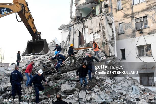 Emergency workers clear debris at a damaged building in Thumane, 34 kilometres northwest of capital Tirana, after an earthquake hit Albania, on...