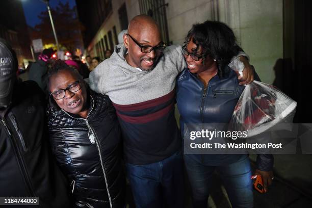 Mary Stewart, left, walks with her son, Andrew Stewart and her daughter, Ulonda Stewart, Andrew's sister after he along with Alfred Chestnut and...