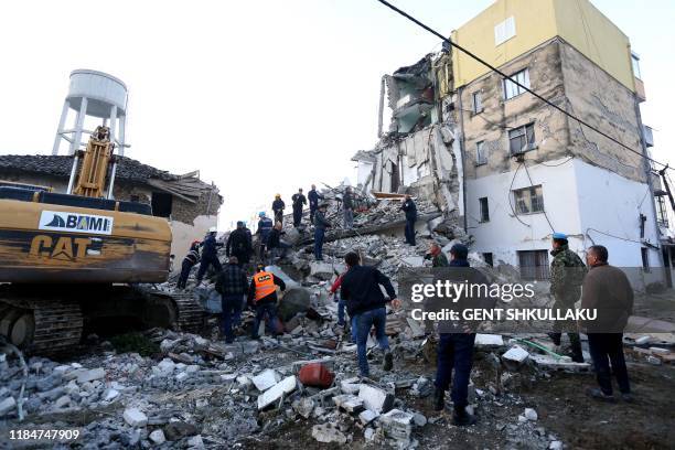 Emergency workers clear debris at a damaged building in Thumane, 34 kilometres northwest of capital Tirana, after an earthquake hit Albania, on...