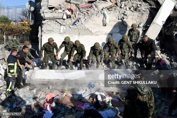 Emergency workers clear debris at a damaged building in Thumane, 34 kilometres northwest of capital Tirana, after an earthquake hit Albania, on...