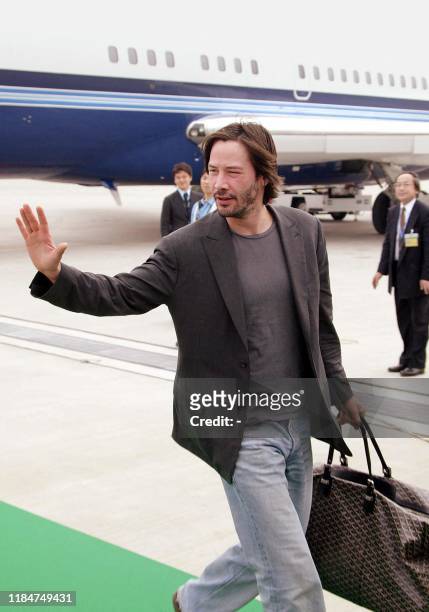 Hollywood movie star Keanu Reeves waves to wellwishers upon his arrival at the New Tokyo International Airport in Narita city, suburban Tokyo 23 May...