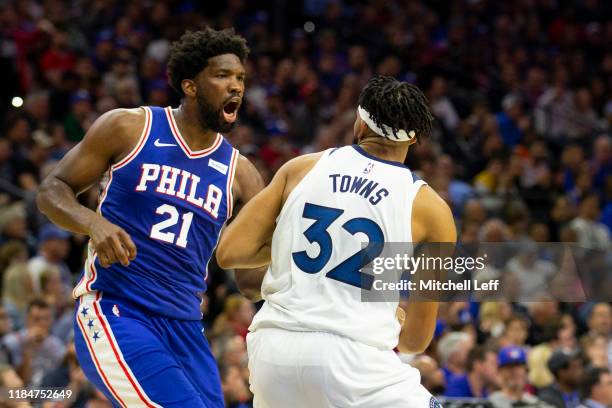 Joel Embiid of the Philadelphia 76ers fights with Karl-Anthony Towns of the Minnesota Timberwolves in the third quarter at the Wells Fargo Center on...