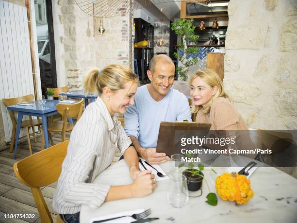 Actor Emmanuelle Beart with her brother Ivan Cerieix and her sister Sarah Cerieix who run the restaurant Les Petits Cousins in Montmartres are...