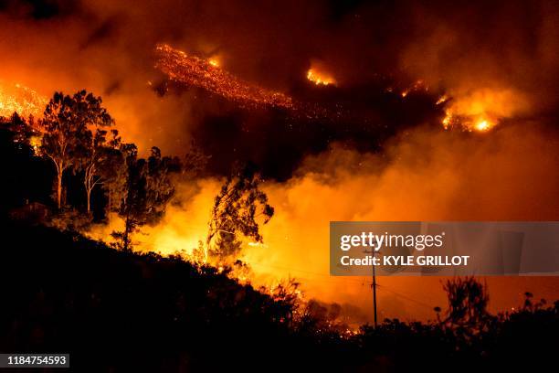 The Cave fire burns a hillside in Santa Barbara, California on November 26, 2019. - The wind-driven brush fire that started late on November 25, 2019...