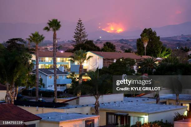 The Cave fire burns a hillside above houses in Santa Barbara, California on November 26, 2019. The wind-driven brush fire that started late on...