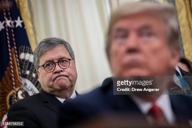 Attorney General William Barr and U.S. President Donald Trump attend a signing ceremony for an executive order establishing the Task Force on Missing...