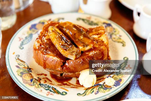 close up of french toast with caramel and banana on a plate - pain perdu stock pictures, royalty-free photos & images