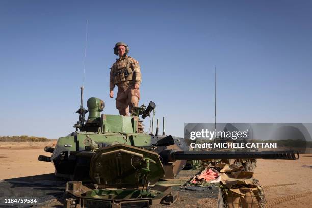 Adrein a gunman, poses for a portrait on an Armoured Personnel Carrier of the French Army during the Barkhane operation in northern Burkina Faso on...