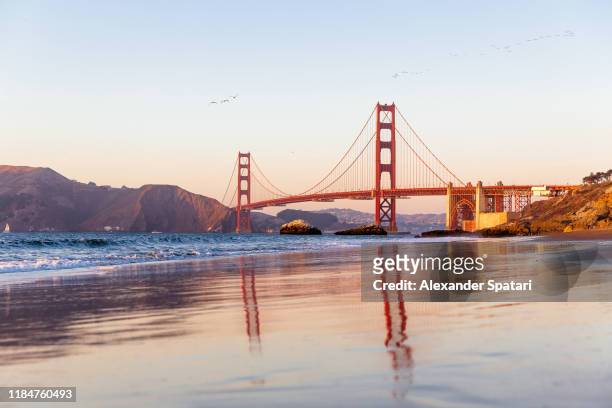 golden bridge and baker beach in san francisco, california - california stock-fotos und bilder