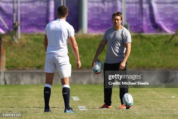 Ex England player Jonny Wilkinson looks on as England captain Owen Farrell practises his penalty kicks following the England Captain's Run at Fuchu...