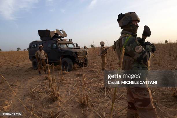 Soldier of the French Army patrols a rural area during the Barkhane operation in northern Burkina Faso on November 9, 2019.