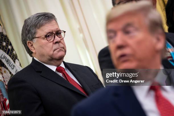 Attorney General William Barr and U.S. President Donald Trump attend a signing ceremony for an executive order establishing the Task Force on Missing...