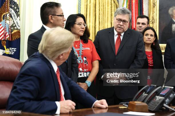 President Donald Trump, left, speaks with William Barr, U.S. Attorney general, center right, after signing an executive order establishing a task...