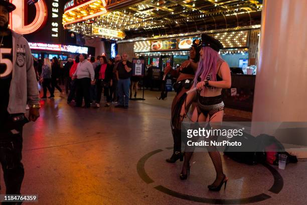Two young men dressed provocatively dance in the Fremont area of Las Vegas, USA, on 11 November 2019, princiopal street of leisure and fun in the...
