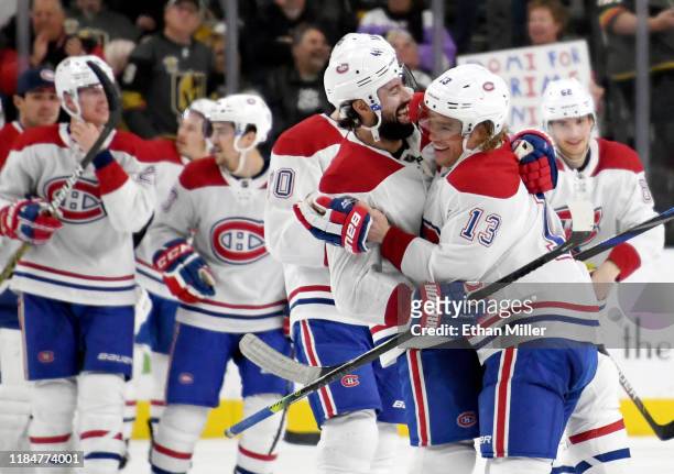 Nate Thompson and Max Domi of the Montreal Canadiens celebrate after Domi scored a goal in overtime to beat the Vegas Golden Knights 5-4 during their...
