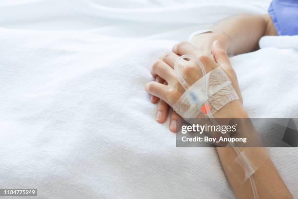 cropped shot of patient hand receiving intravenous fluid directly into a blood vein. - iv going into an arm stock pictures, royalty-free photos & images