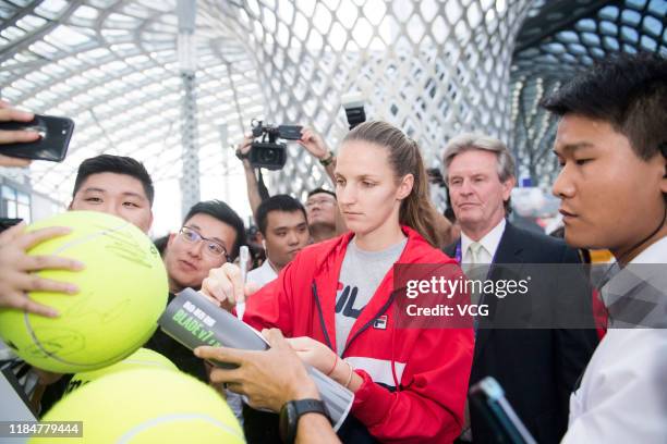 Karolina Pliskova of the Czech Republic signs autograph on a tennis ball during Wuliangye event on Day five of the 2019 WTA Finals at Shenzhen Bay...