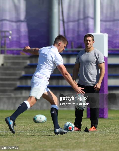 England captain Owen Farrell kicks whilst England 2003 hero Jonny Wilkinson looks on during England captains run ahead of the 2019 Rugby World Cup...