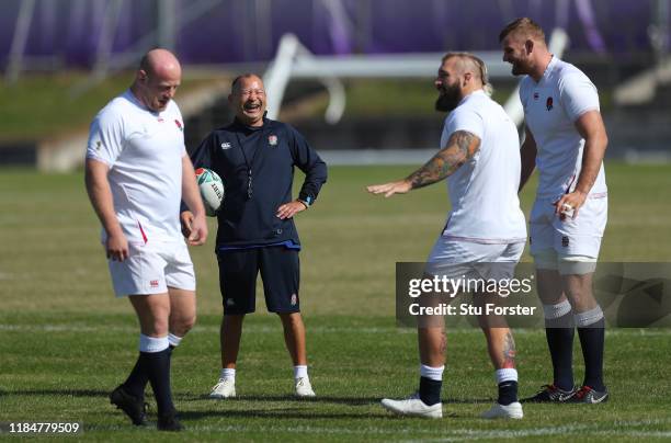 England coach Eddie Jones shares a joke with Joe Marler as Dan Cole and George Kruis look on during England captains run ahead of the 2019 Rugby...