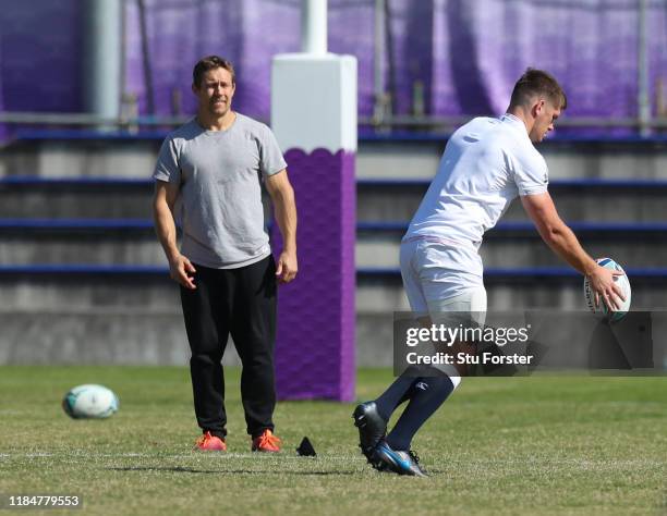 England captain Owen Farrell kicks whilst England 2003 hero Jonny Wilkinson looks on during England captains run ahead of the 2019 Rugby World Cup...