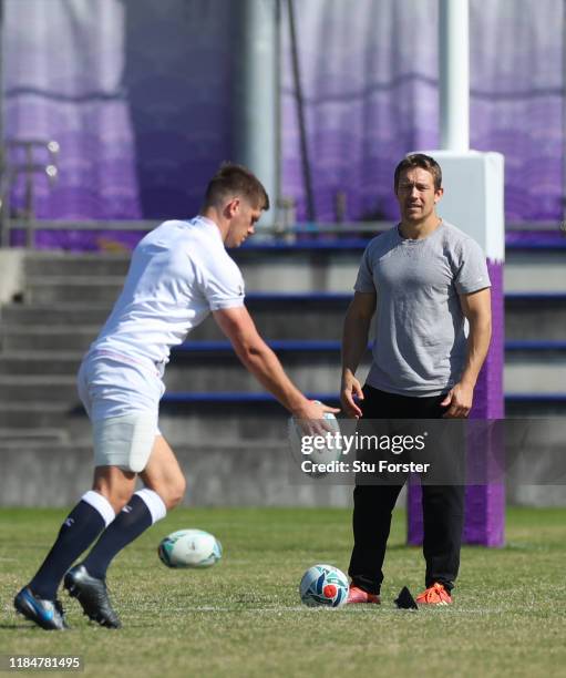 England captain Owen Farrell drop kicks the ball whilst England 2003 hero Jonny Wilkinson looks on during England captains run ahead of the 2019...