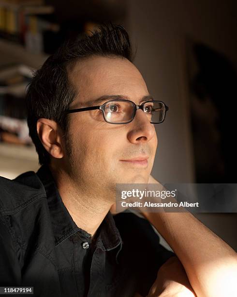 Italian writer Luca Bianchini poses during a portraits session held in his home in Turin on January 25, 2011 in Turin, Italy.