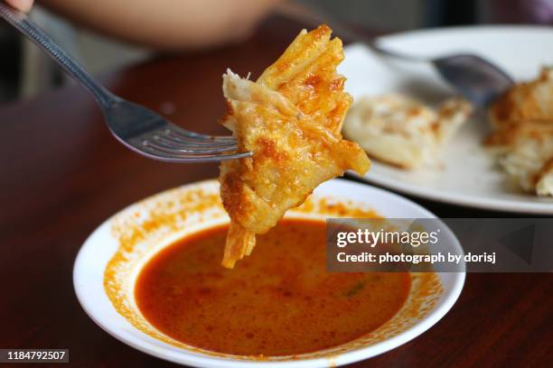roti canai  with curry sauce - roti canai stock pictures, royalty-free photos & images