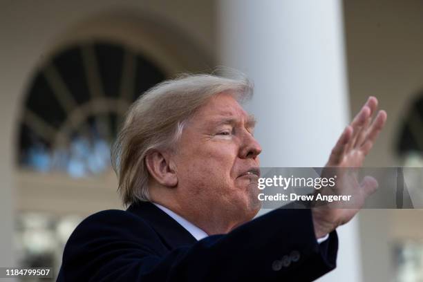 President Donald Trump waves after giving the National Thanksgiving Turkey Butter a presidential pardon during the traditional event in the Rose...