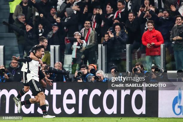 Juventus' Argentine forward Paulo Dybala celebrates with Juventus' Bosnian midfielder Miralem Pjanic after opening the scoring during the UEFA...