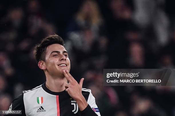 Juventus' Argentine forward Paulo Dybala celebrates after opening the scoring during the UEFA Champions League Group D football match Juventus Turin...