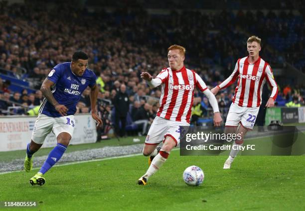 Nathaniel Mendez-Laing of Cardiff City FC and Ryan Woods of Stoke City during the Sky Bet Championship match between Cardiff City and Stoke City at...