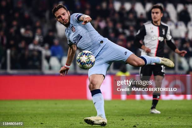 Atletico Madrid's Spanish midfielder Saul Niguez shoots on goal during the UEFA Champions League Group D football match Juventus Turin vs Atletico...