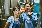 Hispanic Women Checking Quality of Craft Beer in Brewery