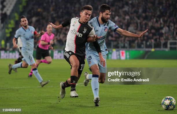 Paulo Dybala of Juventus competes for the ball with Felipe of Club Atletico de Madrid during the UEFA Champions League group D match between Juventus...