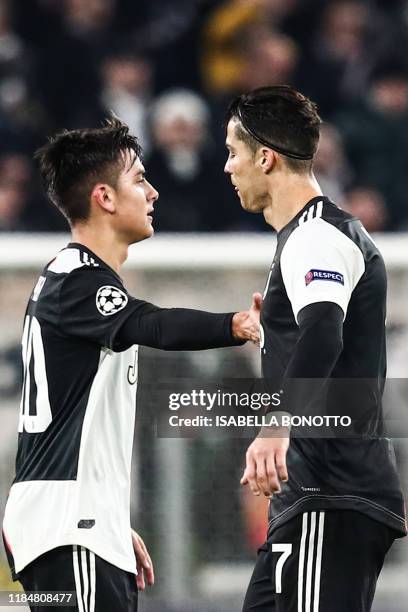 Juventus' Argentine forward Paulo Dybala and Juventus' Portuguese forward Cristiano Ronaldo tap hands during the UEFA Champions League Group D...