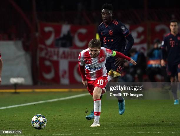 Marko Marin of Crvena Zvezda and Jerome Boateng of FC Bayern Muenchen battle for the ball during the UEFA Champions League group B match between...