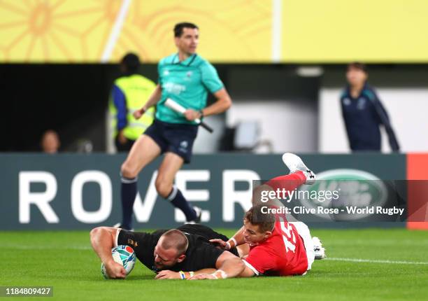 Joe Moody of New Zealand touches down to score his team's first try under pressure from Hallam Amos of Wales during the Rugby World Cup 2019 Bronze...