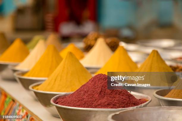 silver bowls filled with turmeric and sumac in a spice bazaar - garam masala stock pictures, royalty-free photos & images